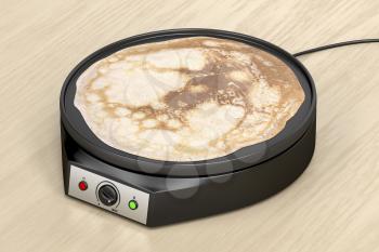 Electric pancake maker on wooden table