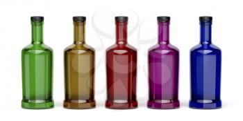 Glass bottles with different colors on white background