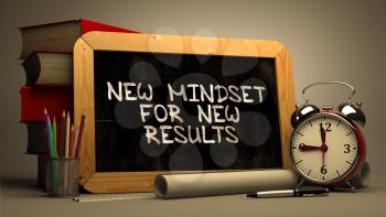 Handwritten New Mindset for New Results on a Chalkboard. Composition with Chalkboard and Stack of Books, Alarm Clock and Rolls of Paper on Blurred Background. Toned Image. 3D Render.