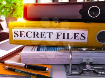 Yellow Office Folder with Inscription Secret Files on Office Desktop with Office Supplies and Modern Laptop. Secret Files Business Concept on Blurred Background. Secret Files - Toned Image. 3D.