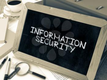 Handwritten Information Security on a Chalkboard. Composition with Chalkboard and Ring Binders, Office Supplies, Reports on Blurred Background. Toned Image. 3D Render.