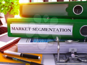Market Segmentation - Green Office Folder on Background of Working Table with Stationery and Laptop. Market Segmentation Business Concept on Blurred Background. Market Segmentation Toned Image. 3D.