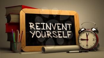 Reinvent Yourself Handwritten on Chalkboard. Time Concept. Composition with Chalkboard and Stack of Books, Alarm Clock and Scrolls on Blurred Background. Toned Image. 3D Render.