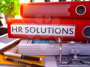 Red Ring Binder with Inscription HR - Human Resource - Solutions on Background of Working Table with Office Supplies and Laptop. HR Solutions Business Concept on Blurred Background. 3D Render.