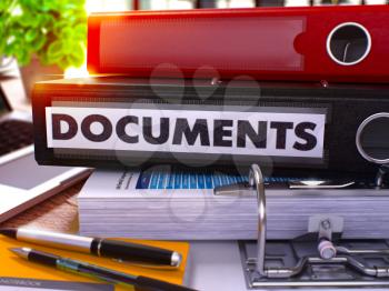 Black Office Folder with Inscription Documents on Office Desktop with Office Supplies and Modern Laptop. Documents Business Concept on Blurred Background. Documents - Toned Image. 3D.
