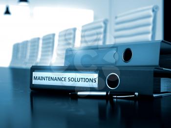 Binder with Inscription Maintenance Solutions on Black Desktop. Maintenance Solutions - Concept. 3D Toned Image.