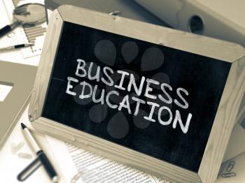 Business Education - Chalkboard with Hand Drawn Text, Stack of Office Folders, Stationery, Reports on Blurred Background. Toned Image. 3D Render.