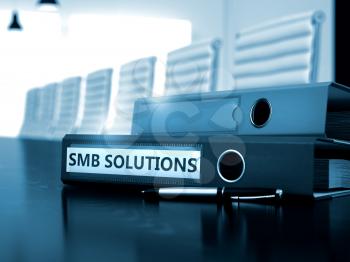 File Folder with Inscription SMB Solutions on Working Office Desktop. SMB Solutions - File Folder on Wooden Desktop. SMB Solutions - Business Concept on Blurred Background. 3D.