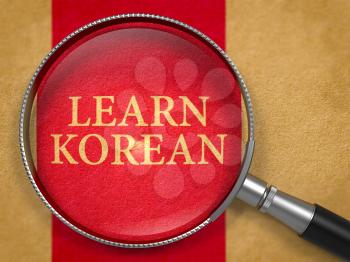 Learn Korean through Loupe on Old Paper with Dark Red Vertical Line Background. 3D Render.