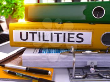 Utilities - Yellow Office Folder on Background of Working Table with Stationery and Laptop. Utilities Business Concept on Blurred Background. Utilities Toned Image. 3D.