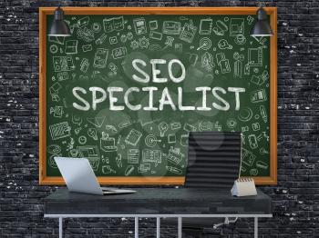 SEO - Search Engine Optimization - Specialist Concept Handwritten on Green Chalkboard with Doodle Icons. Office Interior with Modern Workplace. Dark Brick Wall Background. 3D.
