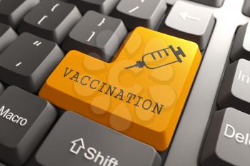 Vaccination Word with Syringe Icon on Orange Button on Black Modern Computer Keyboard. Medical Concept.