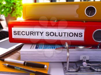 Security Solutions - Red Office Folder on Background of Working Table with Stationery and Laptop. Security Solutions Business Concept on Blurred Background. Security Solutions Toned Image. 3D.