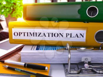 Optimization Plan - Yellow Office Folder on Background of Working Table with Stationery and Laptop. Optimization Plan Business Concept on Blurred Background. Optimization Plan Toned Image. 3D.
