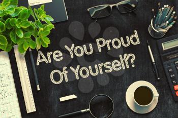 Are You Proud Of Yourself - Black Chalkboard with Hand Drawn Text and Stationery. Top View. 3d Rendering. Toned Image.