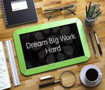 Small Chalkboard with Dream Big Work Hard Concept. Top View of Office Desk with Stationery and Green Small Chalkboard with Business Concept - Dream Big Work Hard. 3d Rendering.