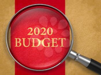 2020 Budget through Loupe on Book Title Page with Dark Red Vertical Line Background.