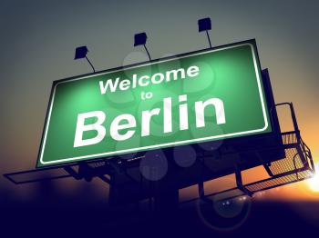 Welcome to Berlin - Green Billboard on the Rising Sun Background.