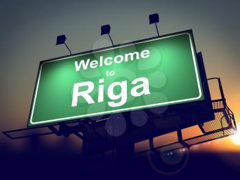 Welcome to Riga - Green Billboard on the Rising Sun Background.
