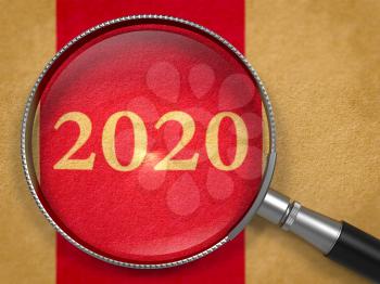 2020 Through Loupe or Magnifying Glass on Paper with Dark Red Vertical Line Background. Business Concept.