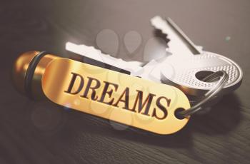 Keys to Dreams - Concept on Golden Keychain over Black Wooden Background. Closeup View, Selective Focus, 3D Render. Toned Image.