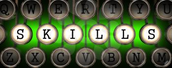 Skills on Old Typewriter's Keys on Green Background.