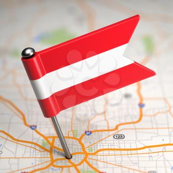 Small Flag of Austria Sticked in the Map Background with Selective Focus.