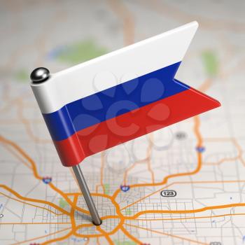 Small Flag of Russia Sticked in the Map Background with Selective Focus.