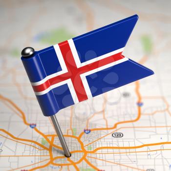 Small Flag of Iceland Sticked in the Map Background with Selective Focus.