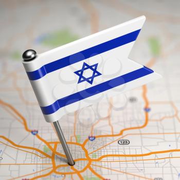 Small Flag of Israel Sticked in the Map Background with Selective Focus.