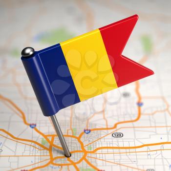 Small Flag of Romania Sticked in the Map Background with Selective Focus.