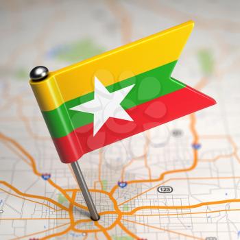 Small Flag of Myanmar on a Map Background with Selective Focus.