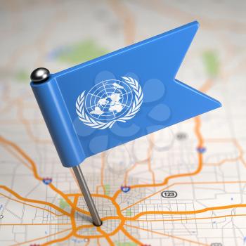 Small Flag of United Nations on a Map Background with Selective Focus.