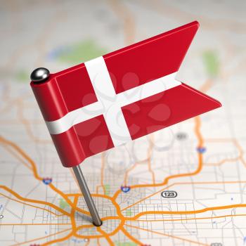 Small Flag of Denmark on a Map Background with Selective Focus.