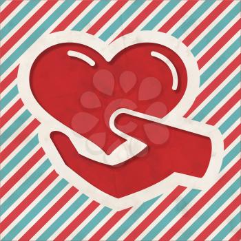 Charity Concept - Icon of Heart in the Hand on Red and Blue Striped Background. Vintage Concept in Flat Design.