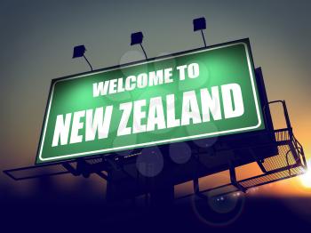 Welcome to New Zealand - Green Billboard on the Rising Sun Background.
