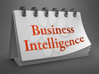 Business Intelligence - Red Words on White Desktop Calendar Isolated on Gray Background.
