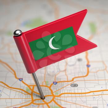 Small Flag of Republic of the Maldives on a Map Background with Selective Focus.