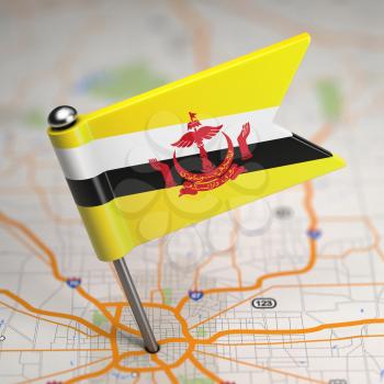 Small Flag of Nation of Brunei, Abode of Peace on a Map Background with Selective Focus.
