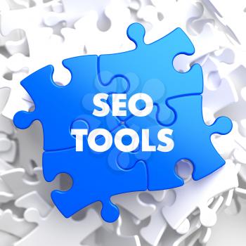 SEO Tools on Blue Puzzle on White Background.