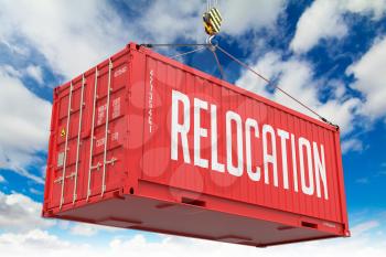 Relocation - Red Cargo Container hoisted with hook on Blue Sky Background.