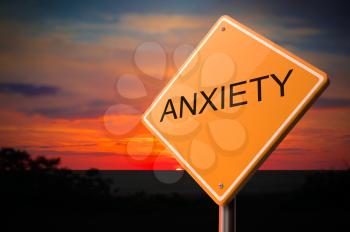 Anxiety on Warning Road Sign on Sunset Sky Background.