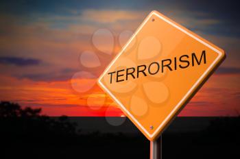 Terrorism on Warning Road Sign on Sunset Sky Background.