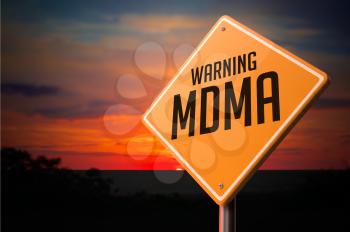 MDMA on Warning Road Sign on Sunset Sky Background.