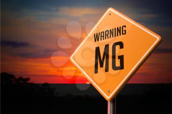 MG on Warning Road Sign on Sunset Sky Background.