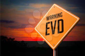 EVD on Warning Road Sign on Sunset Sky Background.