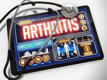 Arthritis - Diagnosis on the Display of Medical Tablet and a Black Stethoscope on White Background.
