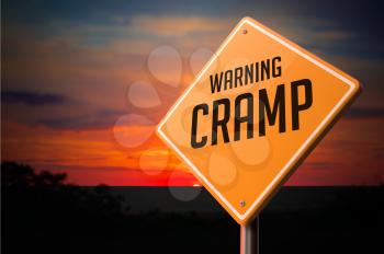Cramp on Warning Road Sign on Sunset Sky Background.