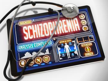 Schizophrenia - Diagnosis on the Display of Medical Tablet and a Black Stethoscope on White Background.