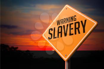 Slavery on Warning Road Sign on Sunset Sky Background.